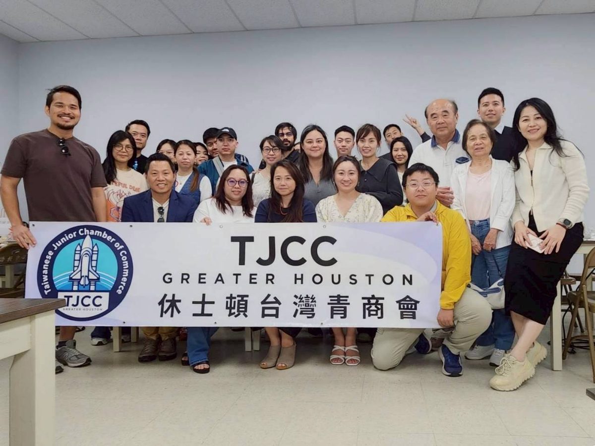 Members of the Taiwanese Junior Chamber of Commerce Greater Houston behind the chapter banner