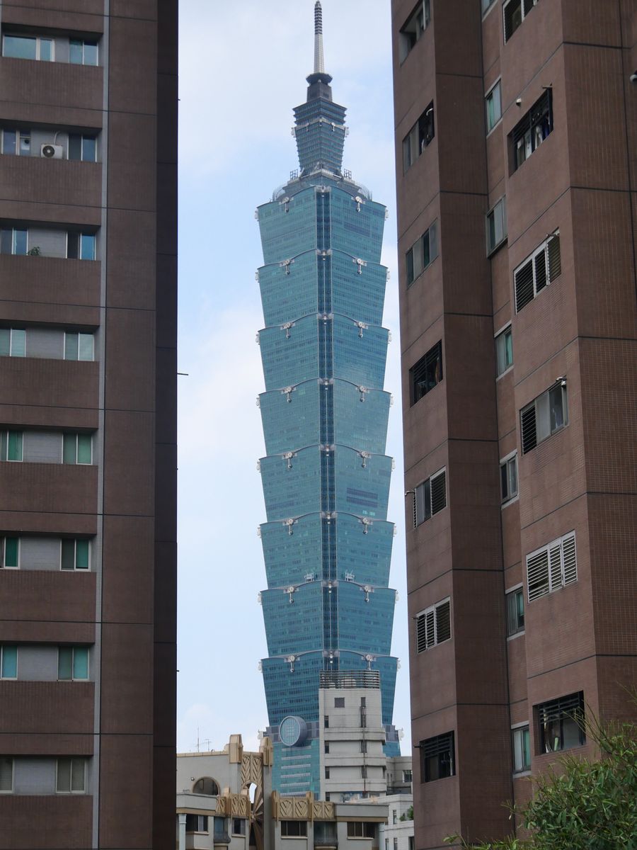 Taipei 101 framed in the gap between two apartment buildings