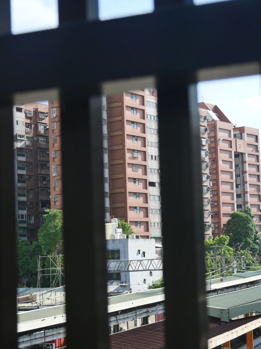 Taiwanese apartment blocks seen through vertical window bars